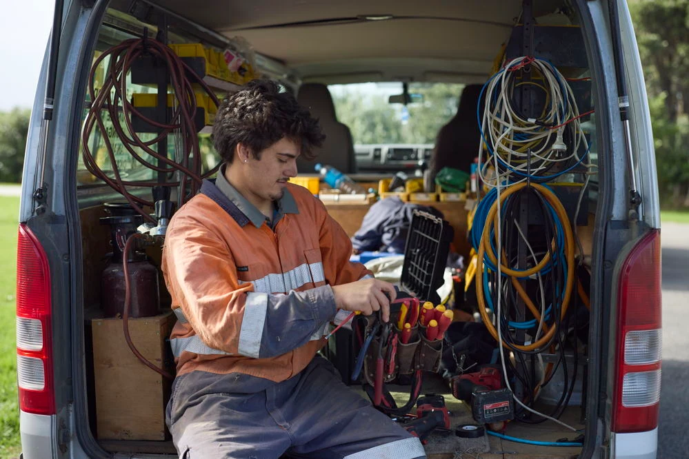 Technician servicing kitchen appliances in a Taranaki home